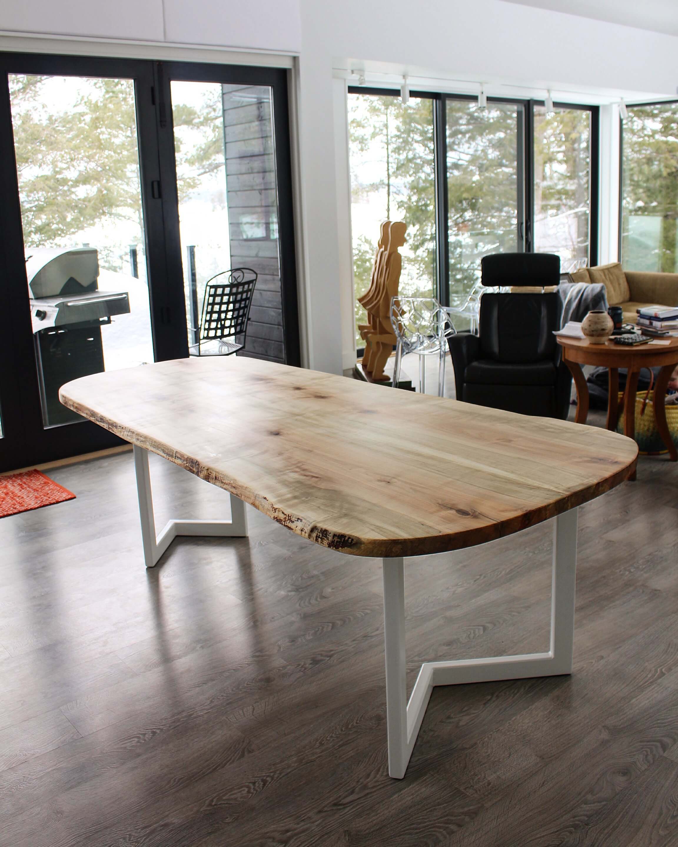 live edge maple table with modern white steel base in arrow design